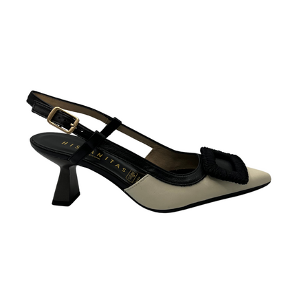 Right facing view of black and ivory leather pump with flared heel and slingback strap. 