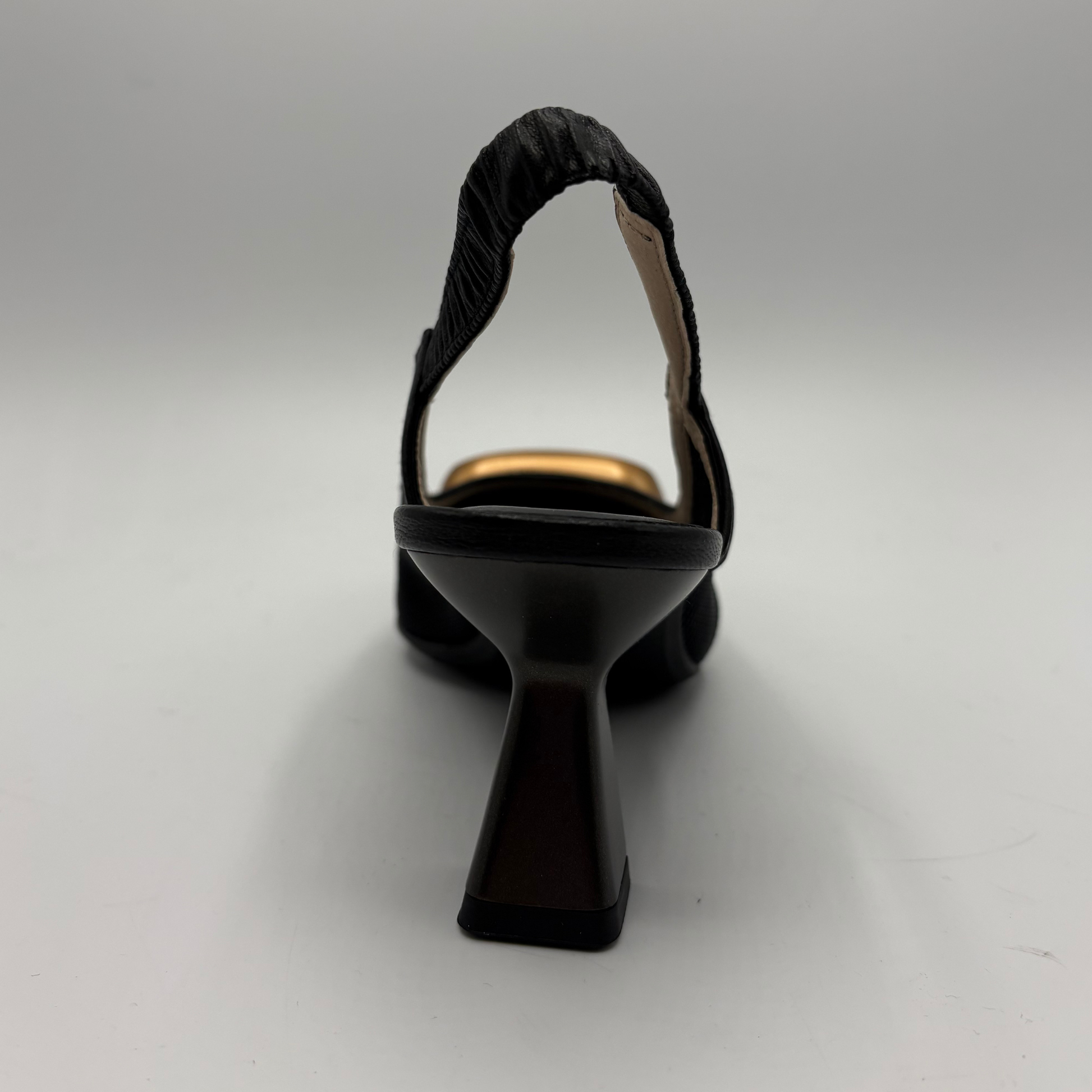 Black high-heeled shoe on a gray background