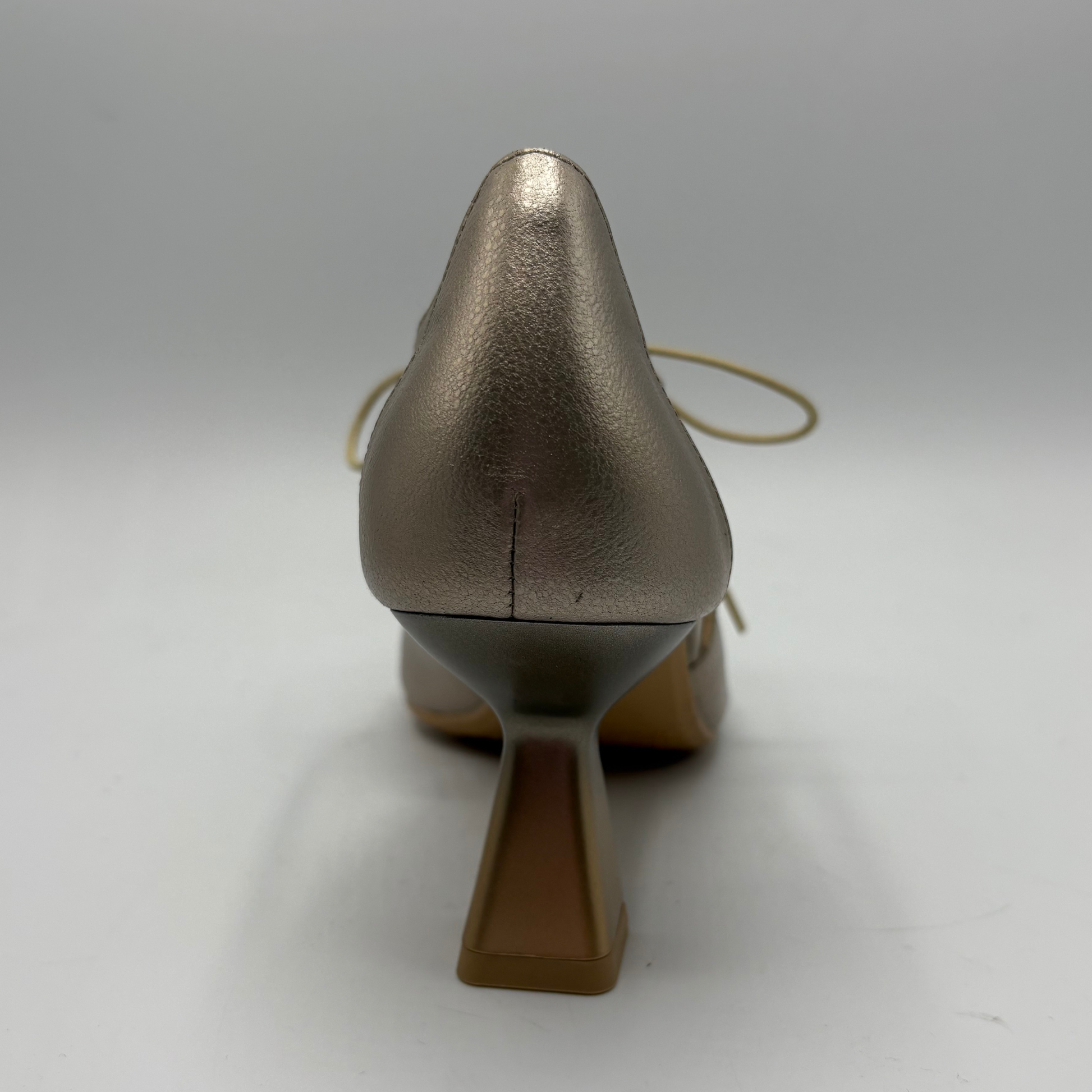 Bronze high-heeled shoe on a white background