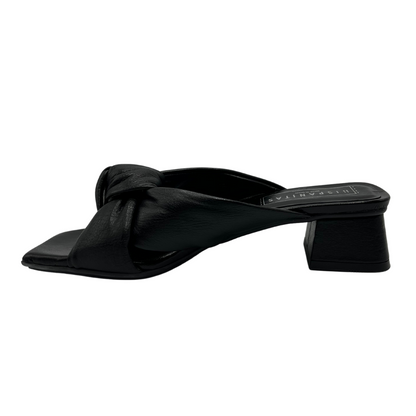 Left view of all leather mule sandal with wrapped 1 inch heel and knot detail on strap