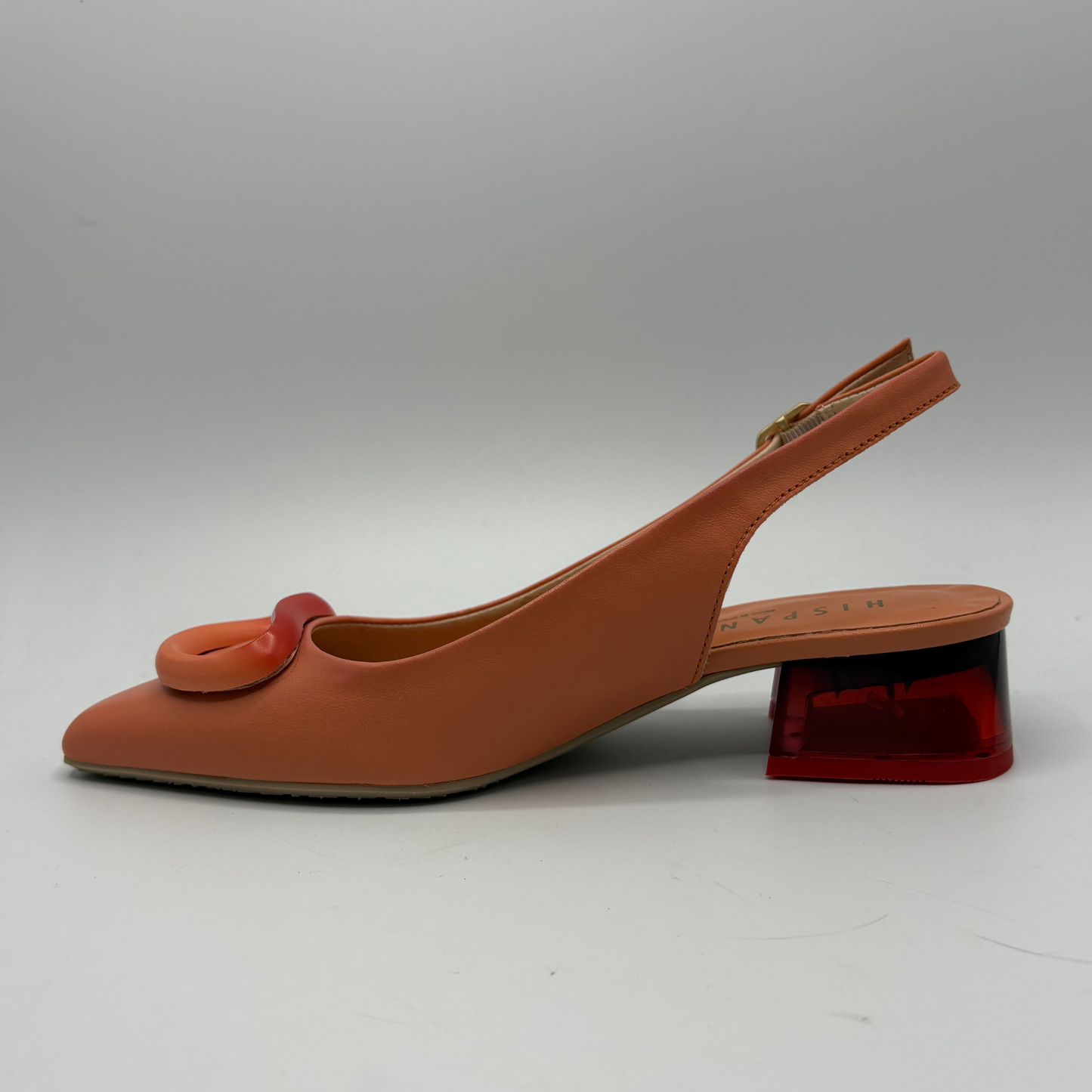 Orange slingback shoe with red translucent heel on a white background