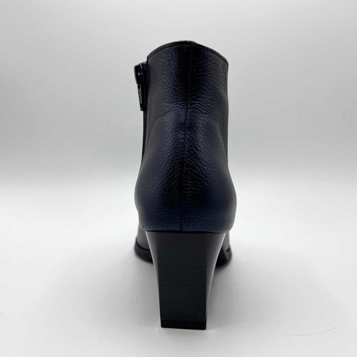 Navy leather ankle boot on a white background