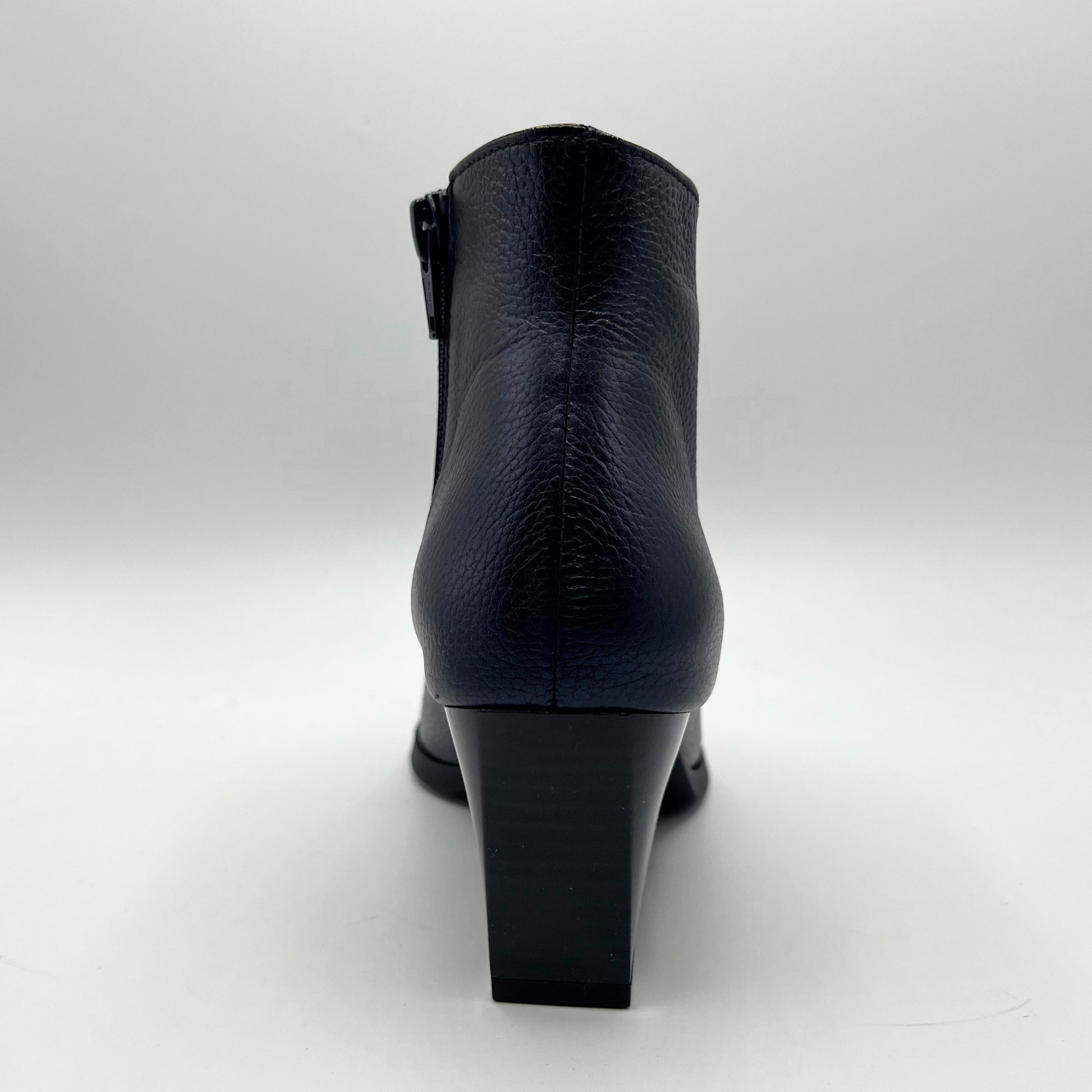 Navy leather ankle boot on a white background