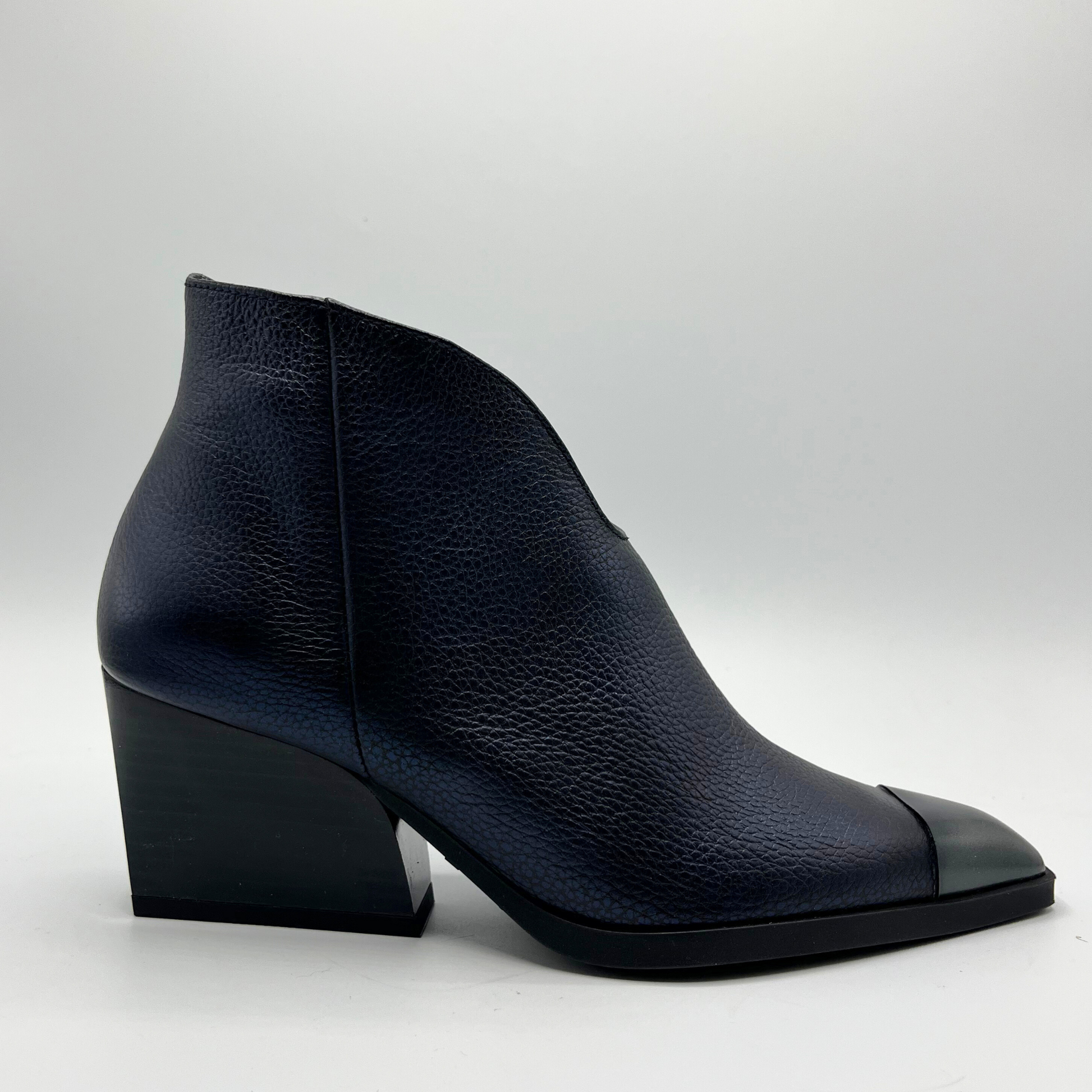 Navy leather ankle boot on a light gray background