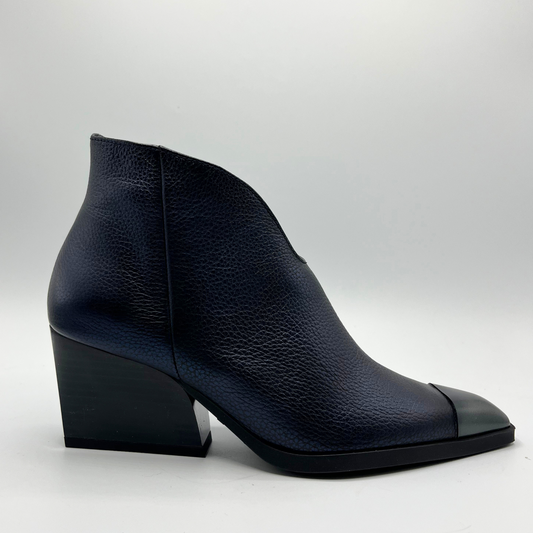 Navy leather ankle boot on a light gray background