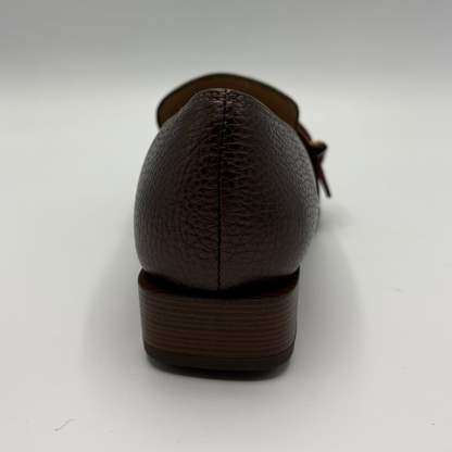 A close-up rear view of a dark brown pebbled leather shoe with a stacked wooden-look heel, shown on a white background.