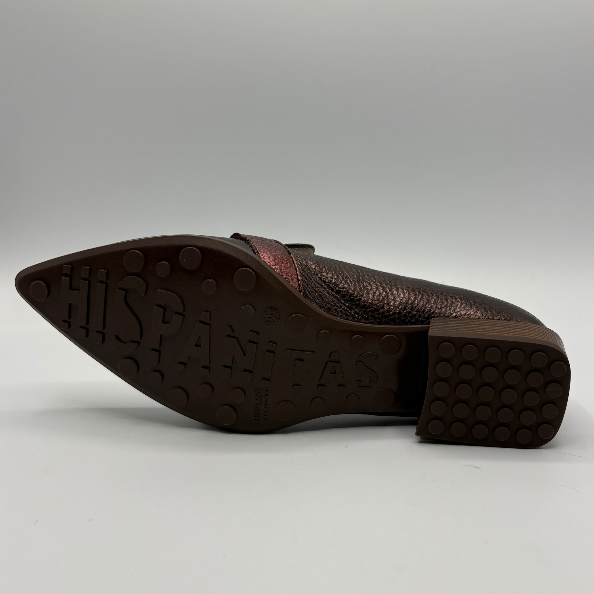 A single brown leather shoe shown from the side, displaying its textured pebbled upper, pointed toe, and a dark brown rubber sole with 'HISPANITAS' embossed in large letters.