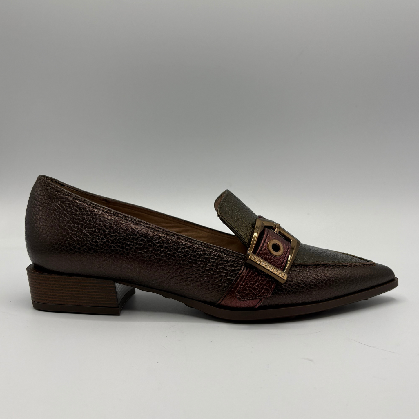 Black loafers on a gray background.