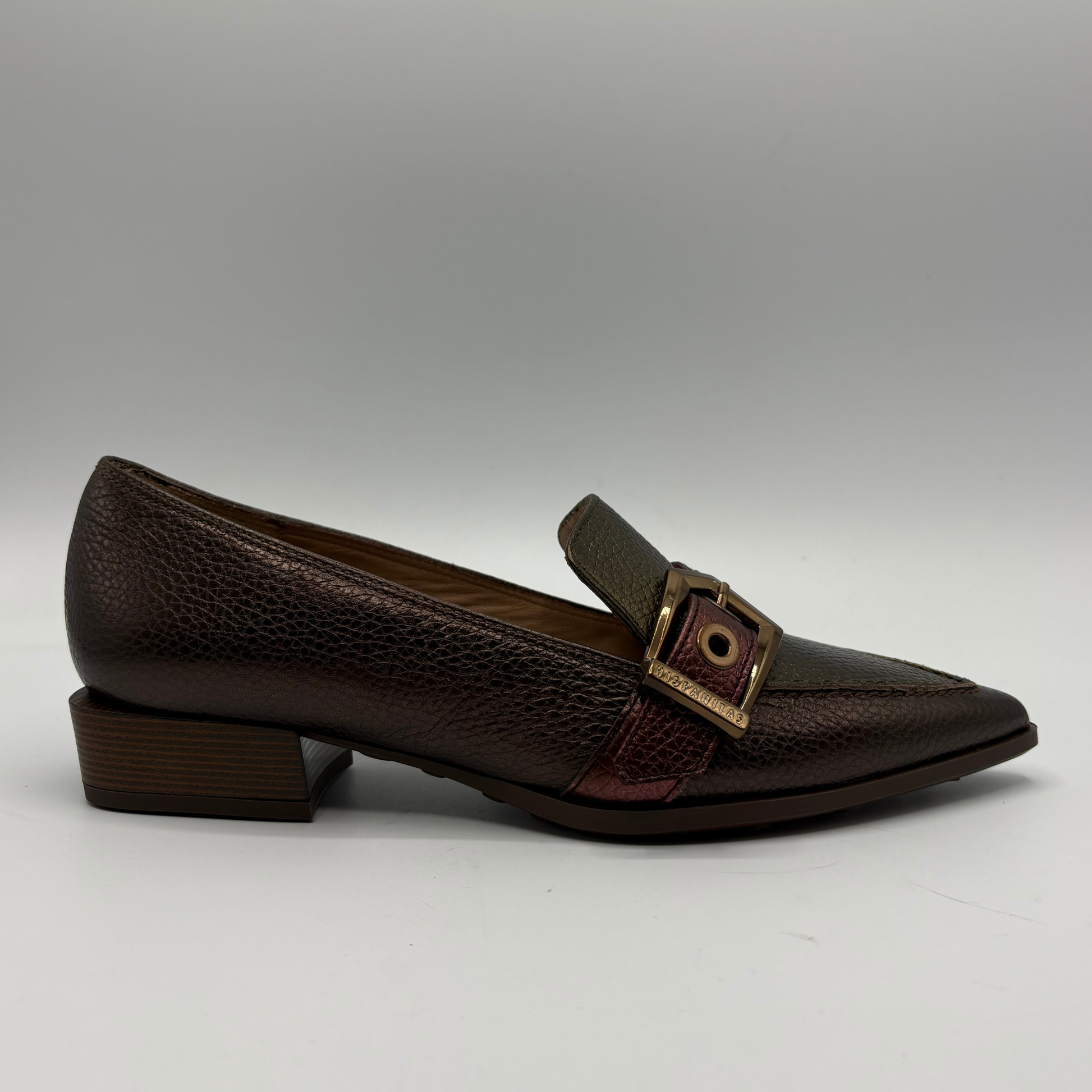 Black loafers on a gray background.