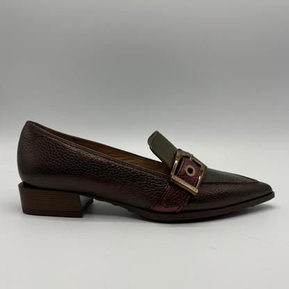 Black loafers on a gray background.