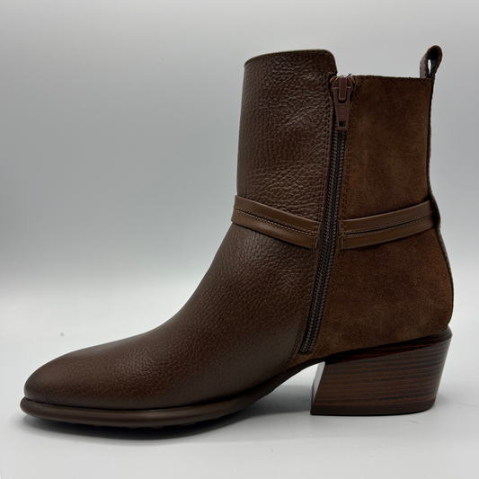 A dark brown ankle boot with a mix of pebbled leather and suede textures, featuring a side zipper and a low stacked block heel, shown against a neutral gray background.