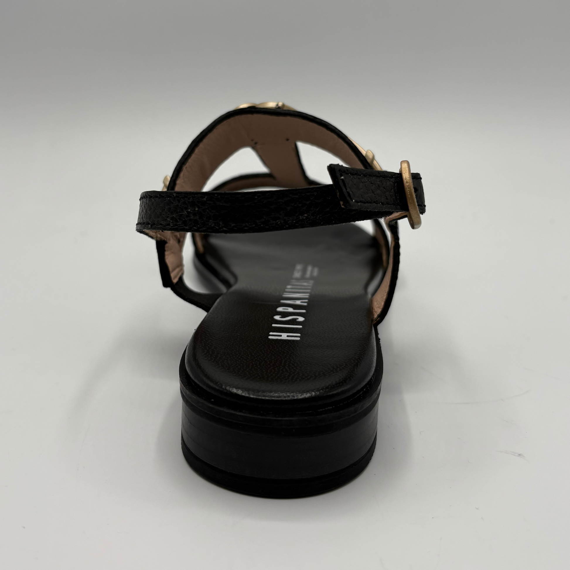 Black sandal with a strap on a gray background