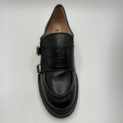 Top view of a black leather loafer with a chunky heel.