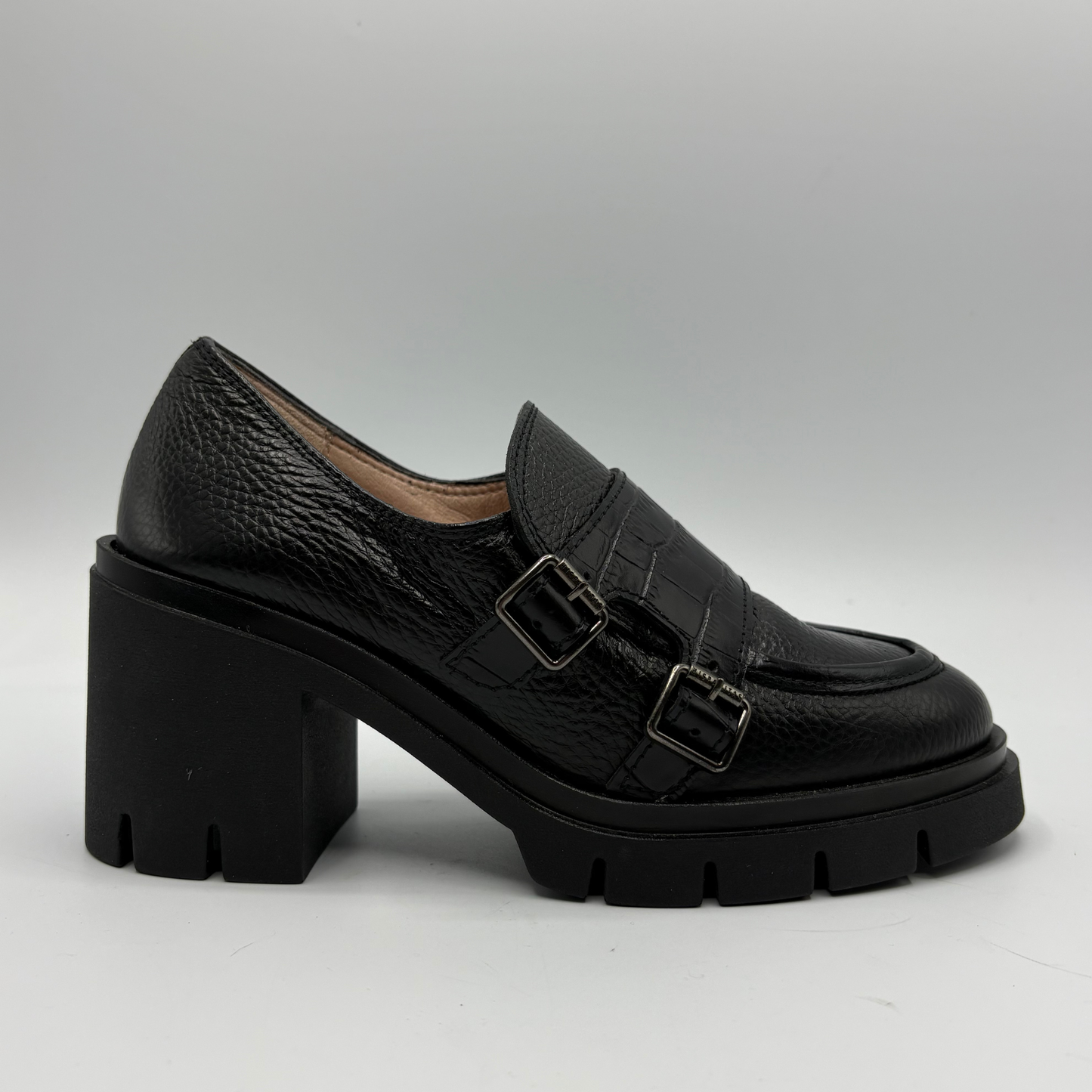 Right facing view of a black leather loafer with a chunky heel.