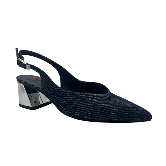 45 degree angled view of jean fabric pump with sling back strap, pointed toe and silver flared heel.