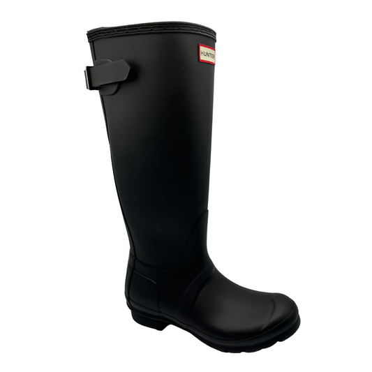 45 degree angled view of black waterproof tall boot with adjustable calf strap and low heel.