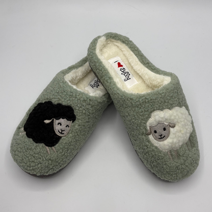 Top view of a pair of green slippers one with a black sheep and one with a white sheep