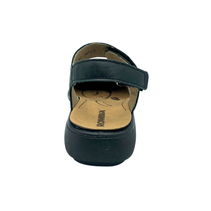 Rear view of a walking sandal in black leather.  Adjustable heel strap