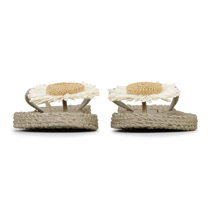 Pair of sandals with jute straps and floral decorations on a white background