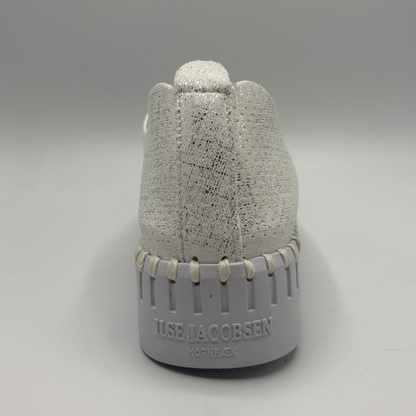 Gray textured bottle with 'Ilse Jacobsen' branding on a gray background
