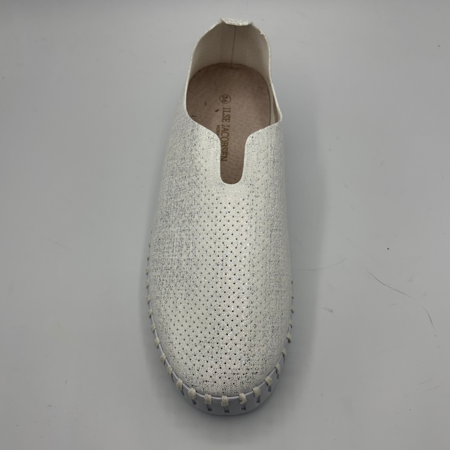 White slipper with textured surface on a gray background