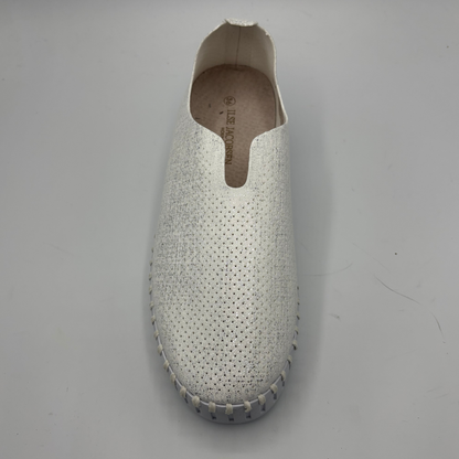 White slipper with textured surface on a gray background