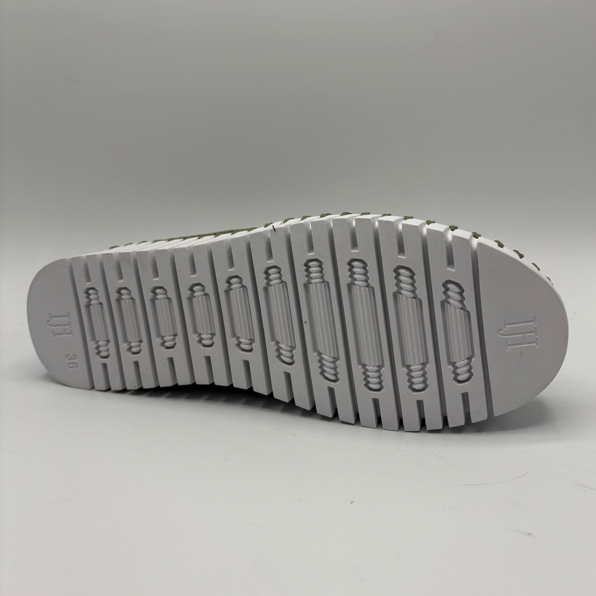 Gray sole of a shoe on a light gray background