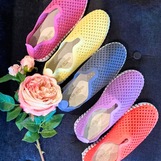 Vibrant colourful Ilse Jacobsen Tulip Slip-Ons with fresh roses on navy background