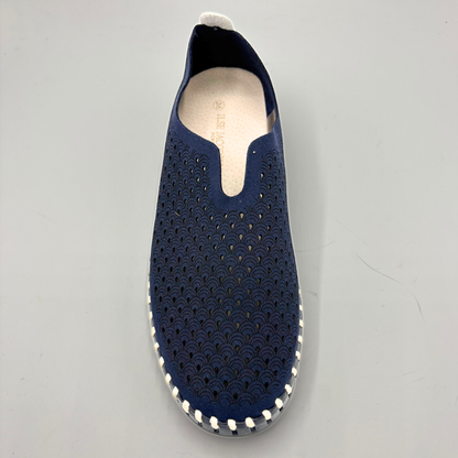 Navy slip-on shoe with perforated design on a gray background