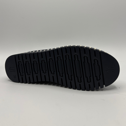 Black sole of a shoe on a gray background