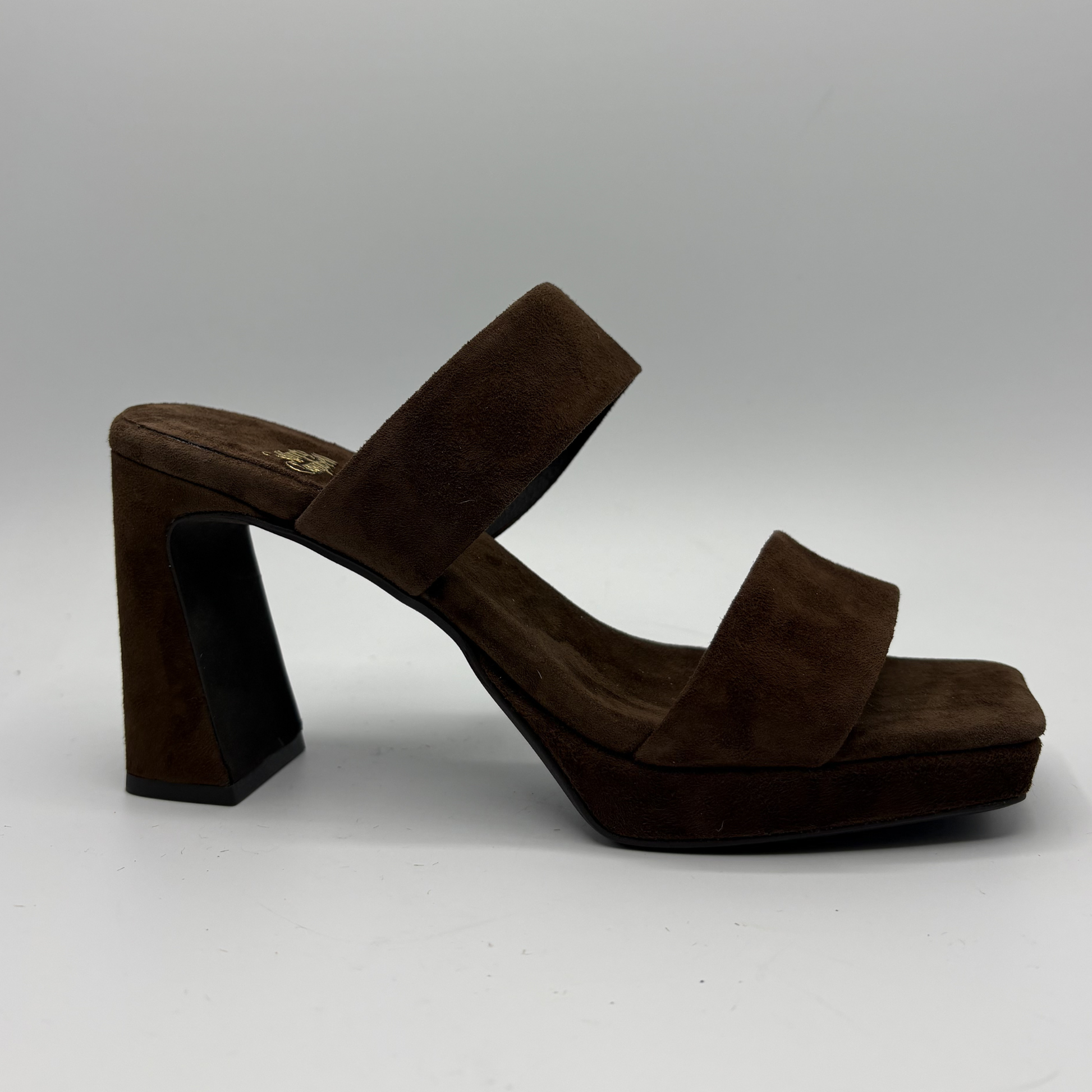 Brown suede sandal with a block heel on a gray background
