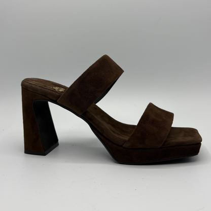Brown suede sandal with a block heel on a gray background