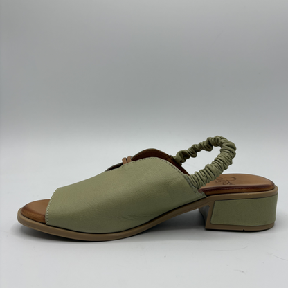 Green sandal with a block heel on a white background