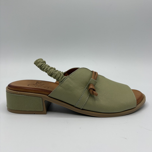 Green sandal with brown sole on a white background