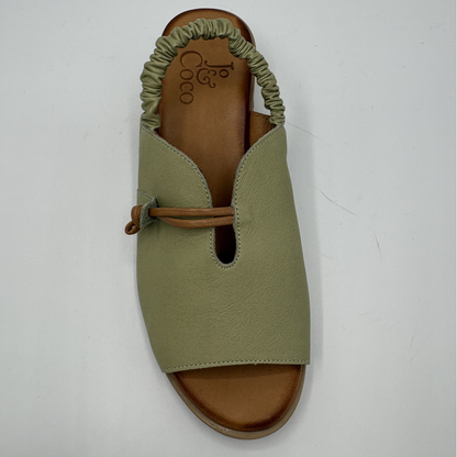 Green sandal with brown sole on a white background
