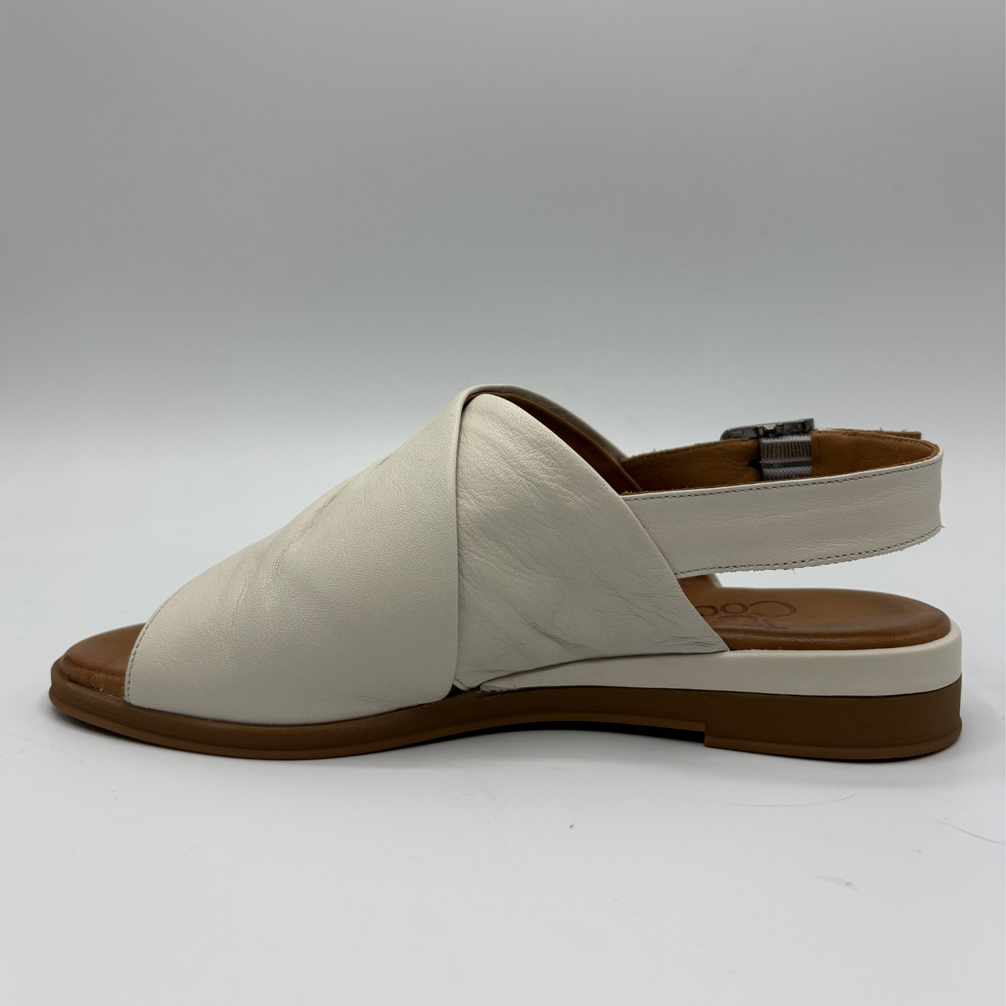 Beige sandal with brown sole on a white background