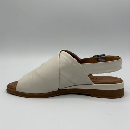 Beige sandal with brown sole on a white background
