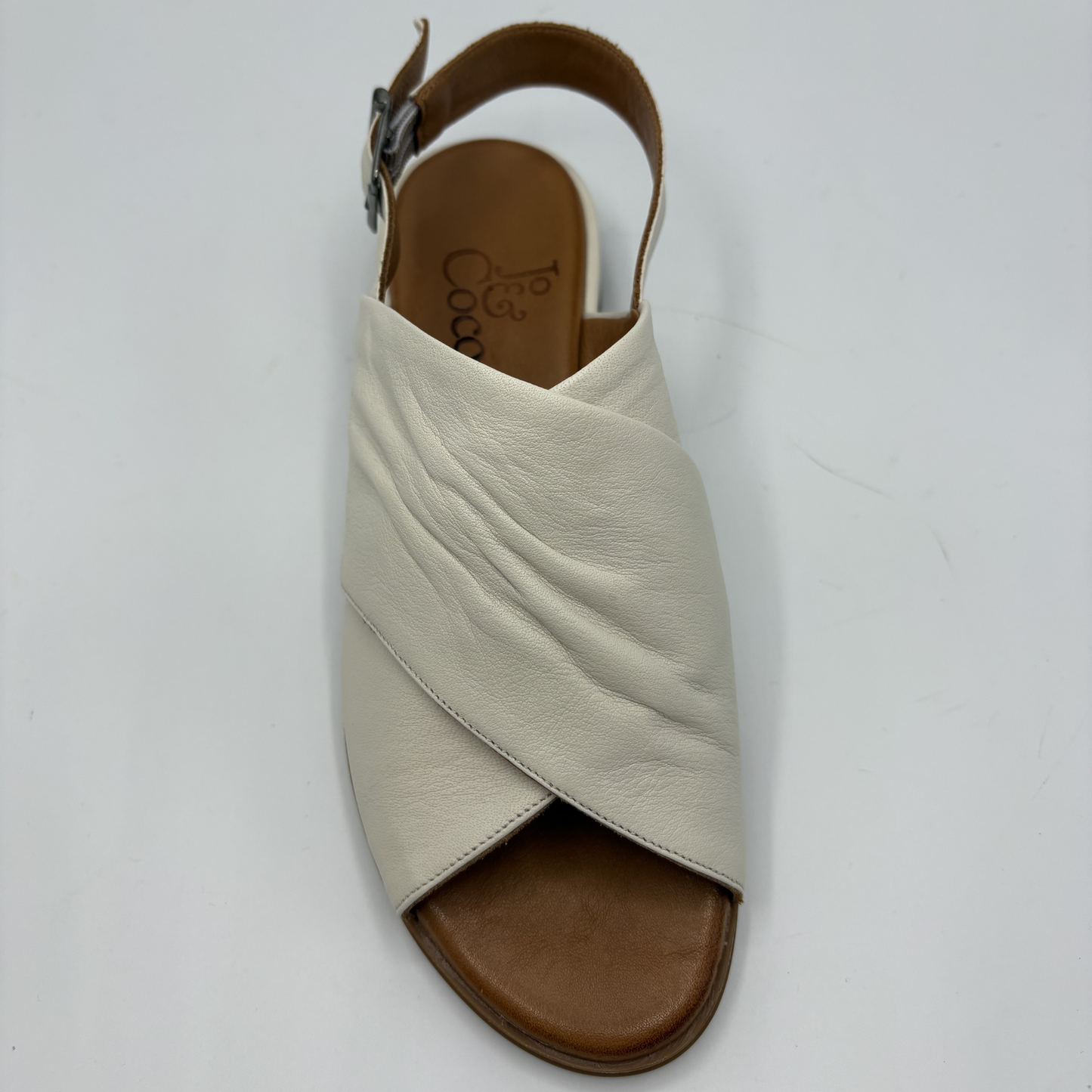 Beige sandal with brown sole on a white background