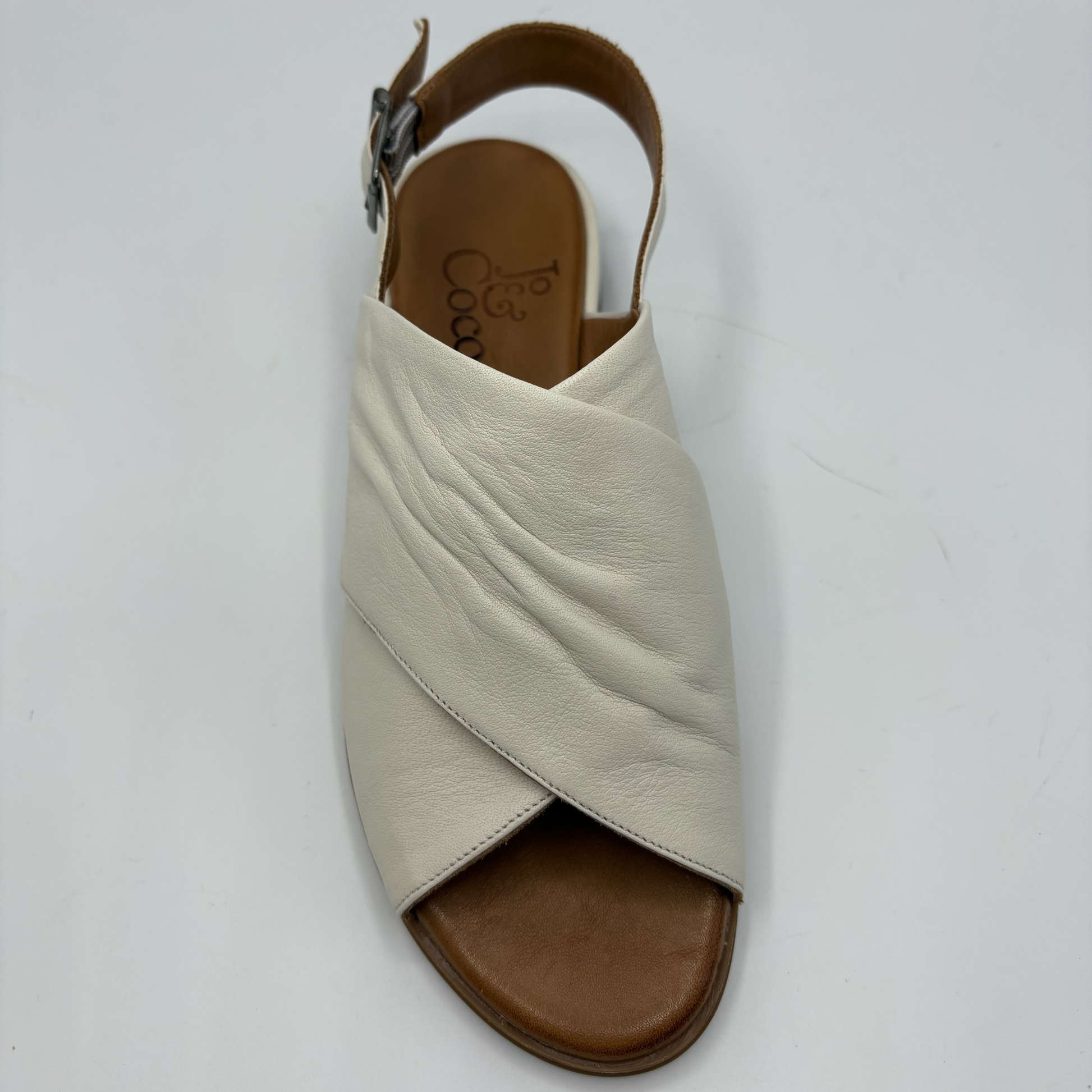 Beige sandal with brown sole on a white background