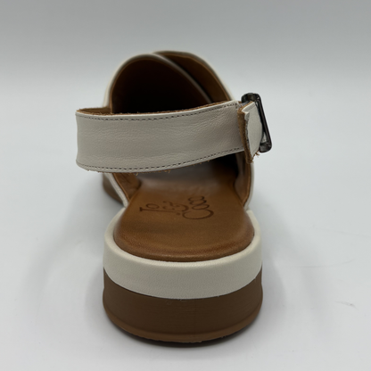 Single sandal with beige strap and brown sole on a white background
