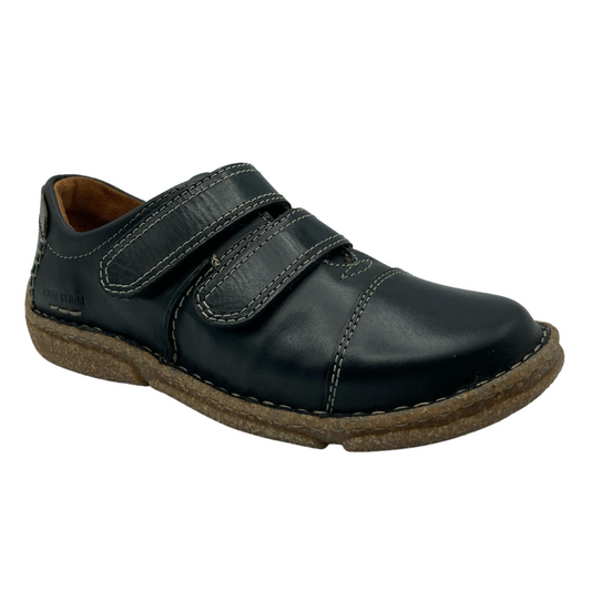 45 degree angled view of black leather walking shoe with double velcro straps and brown rubber outsole