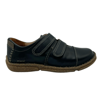 Right facing view of black leather walking shoe with double velcro straps and brown rubber outsole