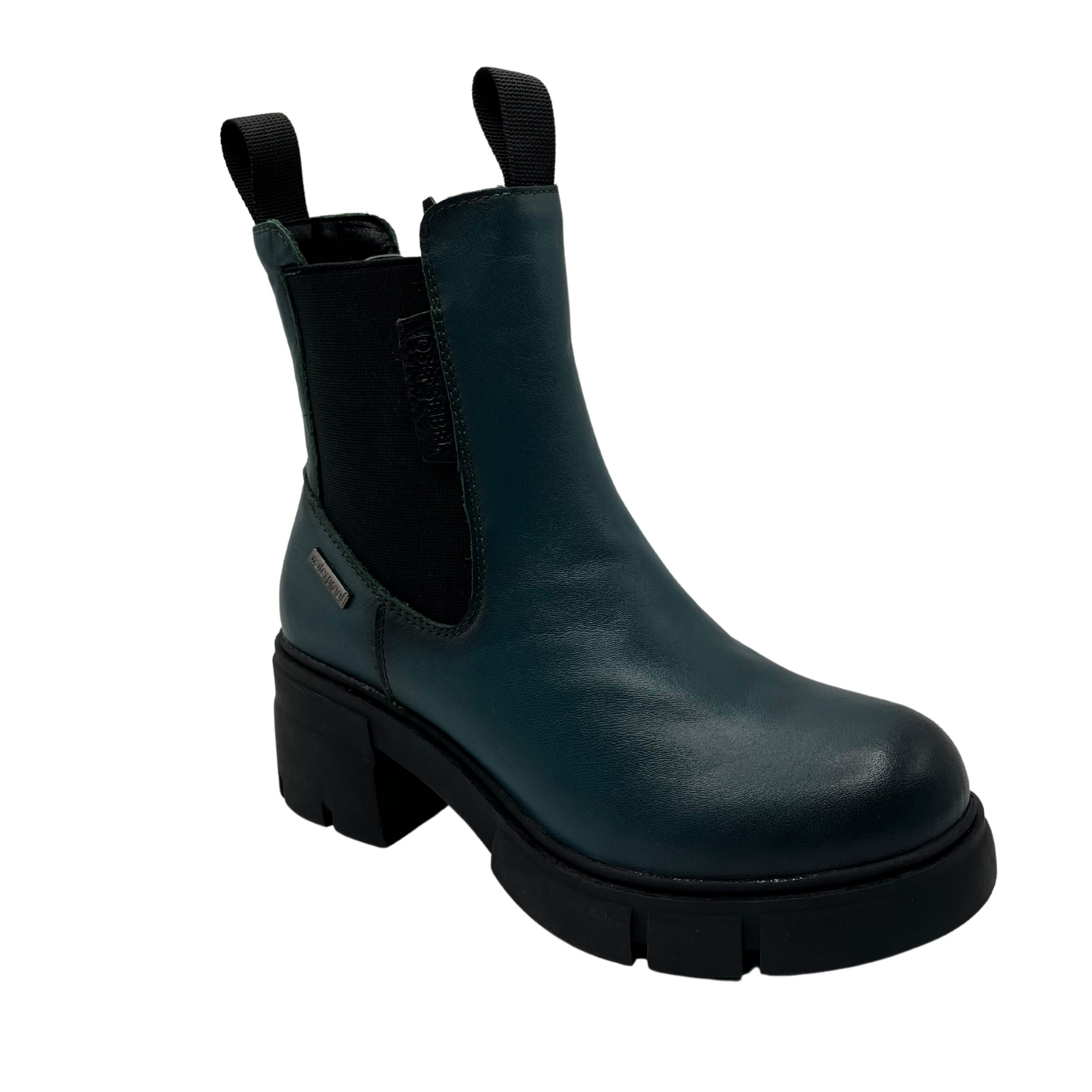 45 degree angled view of petrol blue leather boot with chunky black rubber outsole, double pull on tabs, inner side zipper and outer elastic gore.