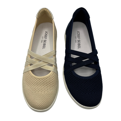 Top view of two mesh sneakers side by side. One is cream coloured and the other is navy coloured. Both have elasticated straps in a crossed design and padded collar.
