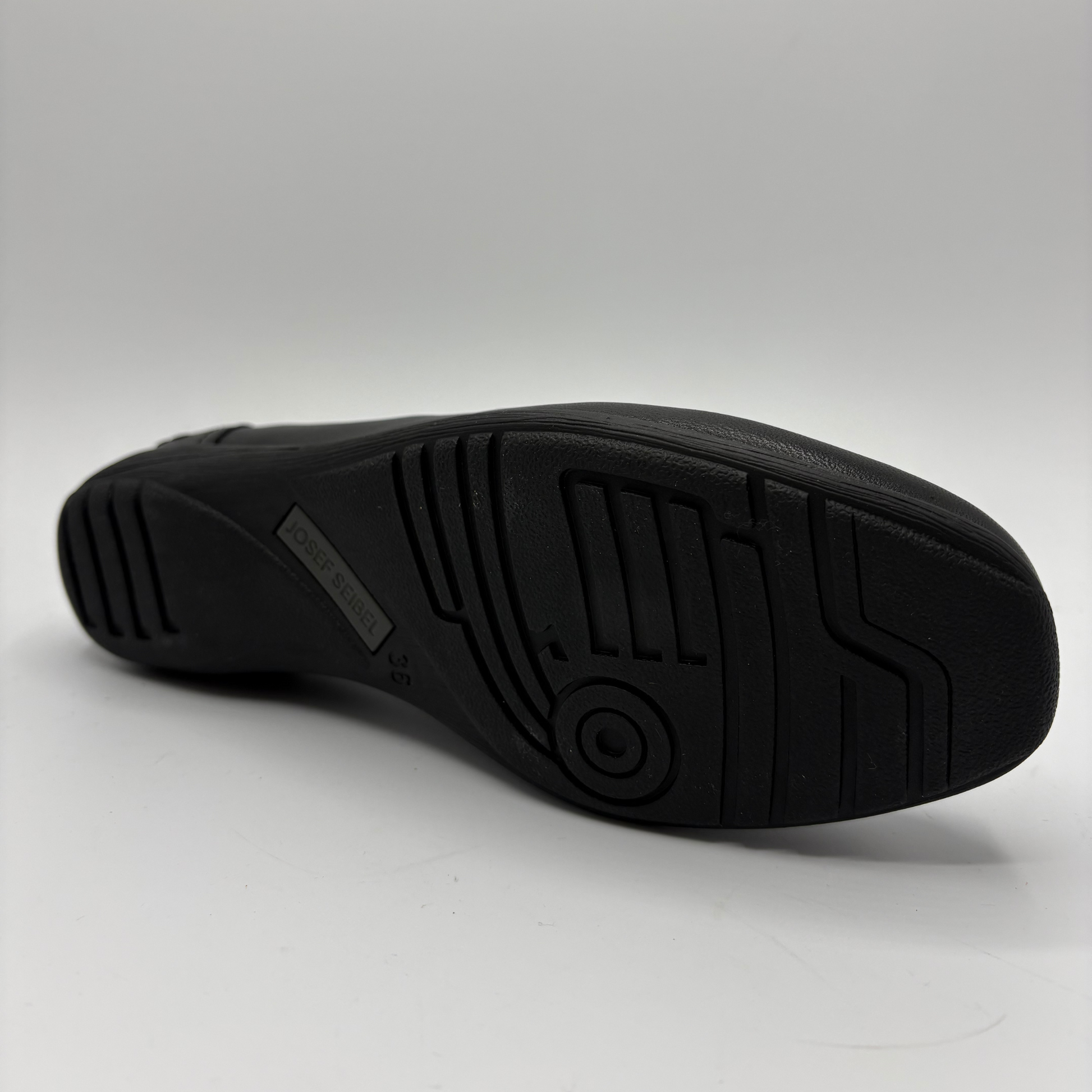 Black shoe sole on a light gray background