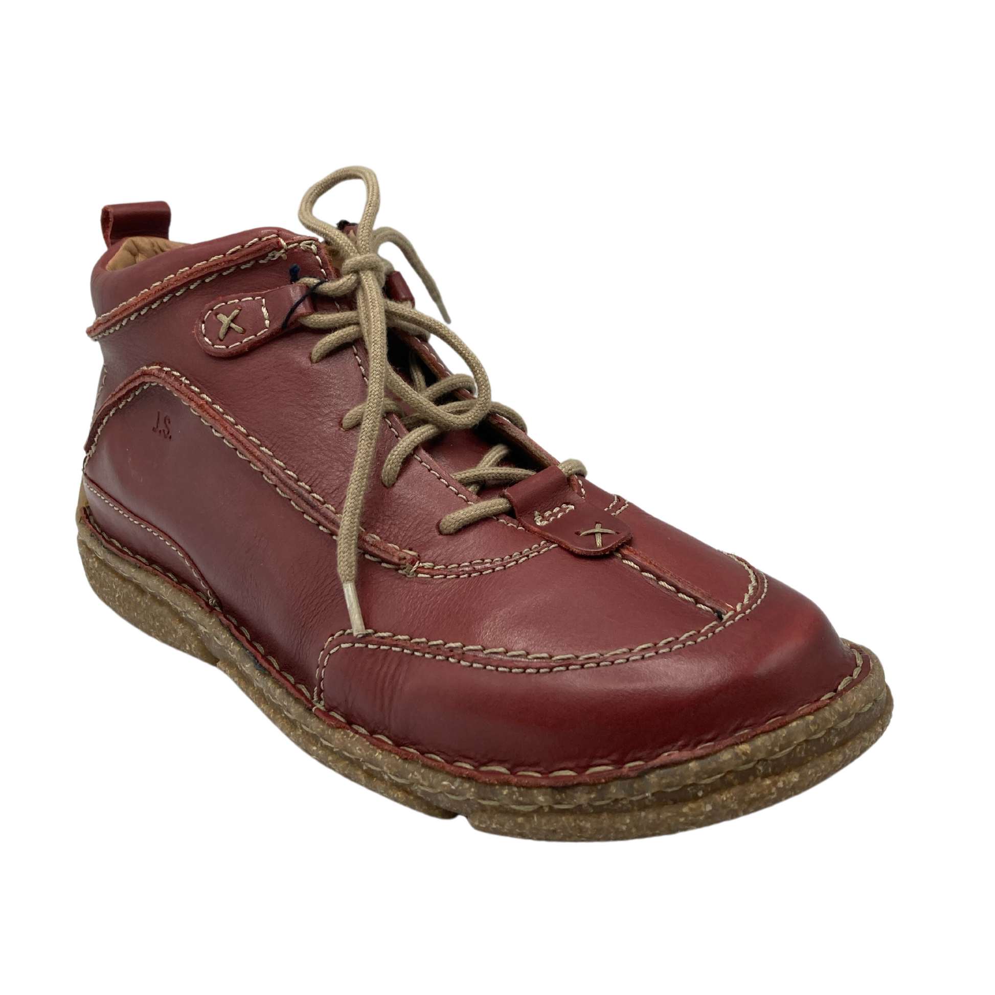 45 degree angled view of red leather shoe with tan laces and tan outsole