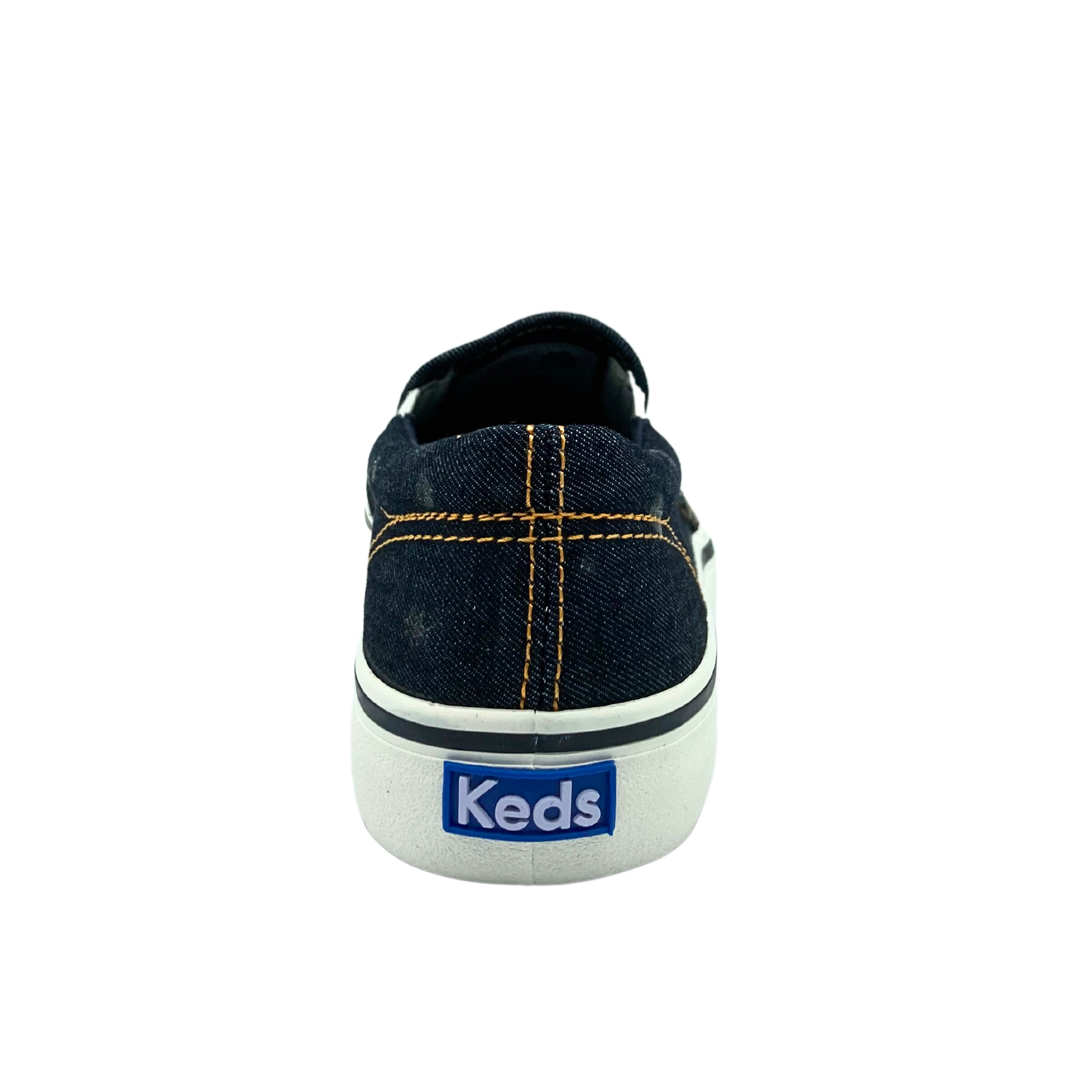 Rear view of a slip on canvas sneaker.   Black denim with yellow stitching around heel cup.  Keds logo on white outsole