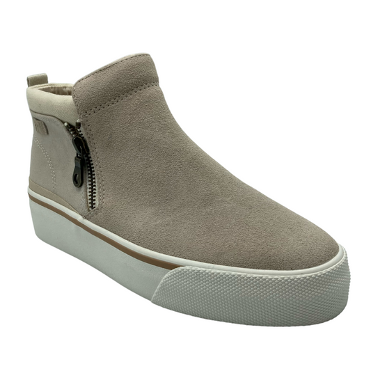 45 degree angled view of latte suede bootie with white rubber outsole and side zipper closure