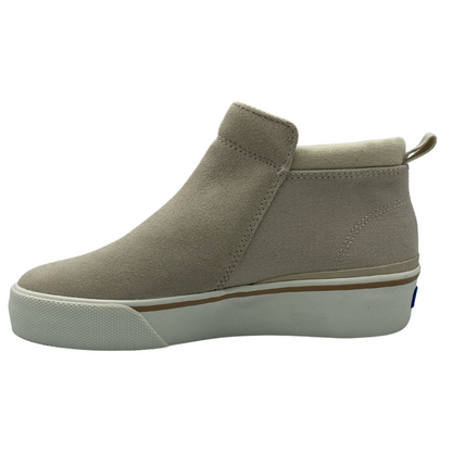 Left facing view of latte suede bootie with white rubber outsole