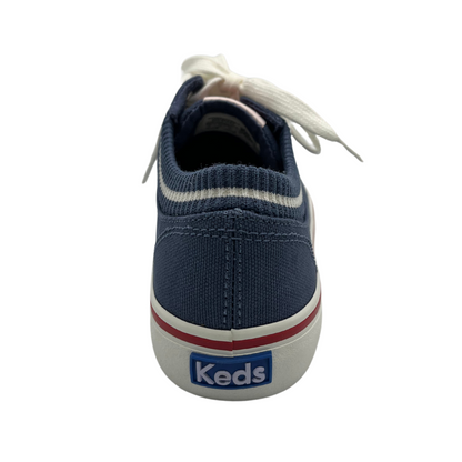 Back view of navy canvas shoes with sock opening, white laces and rubber outsole